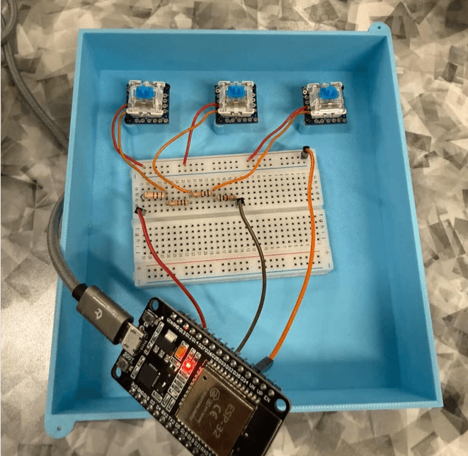 ESP32 and three accessible switches arranged inside the macro pad enclosure