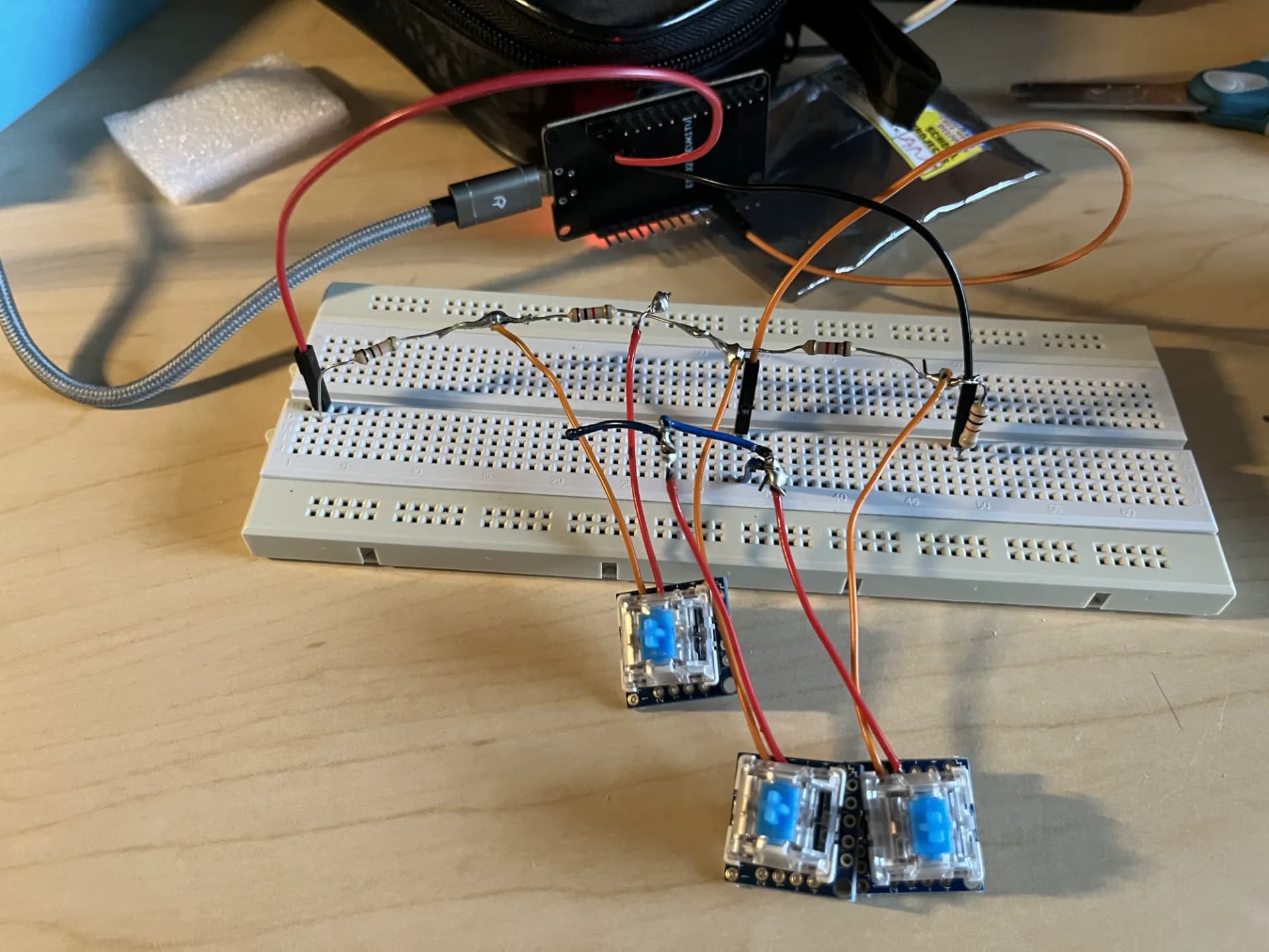 Three switches and an ESP32 connected through a breadboard during testing