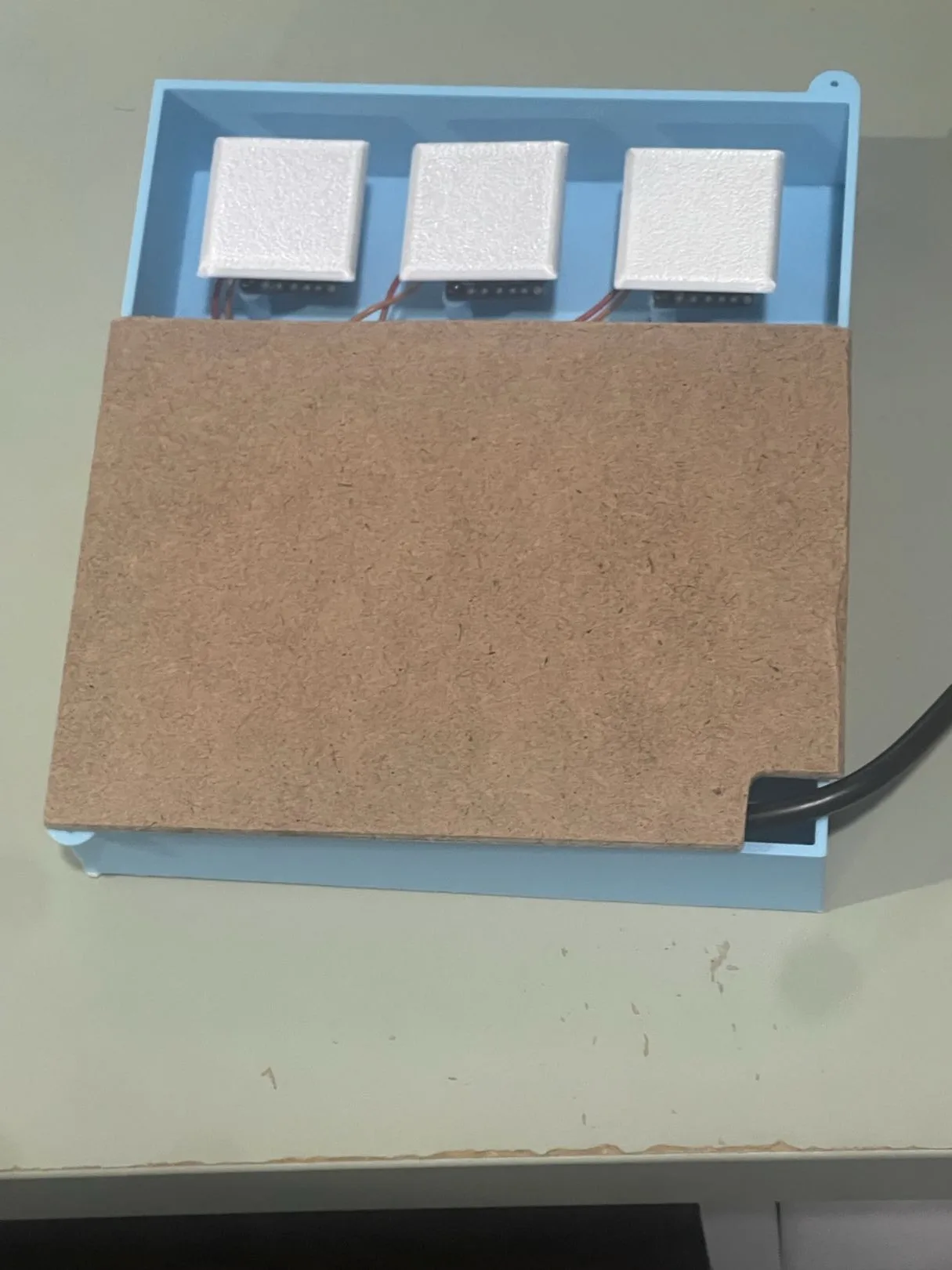 Completed blue accessible macro pad with three large white keycaps and a fitted lid
